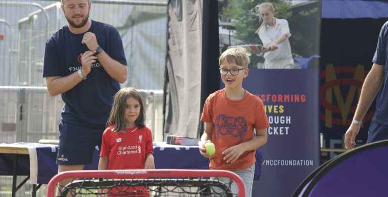 Lords Community Cricket volunteers playing a match with kids at BST Open House