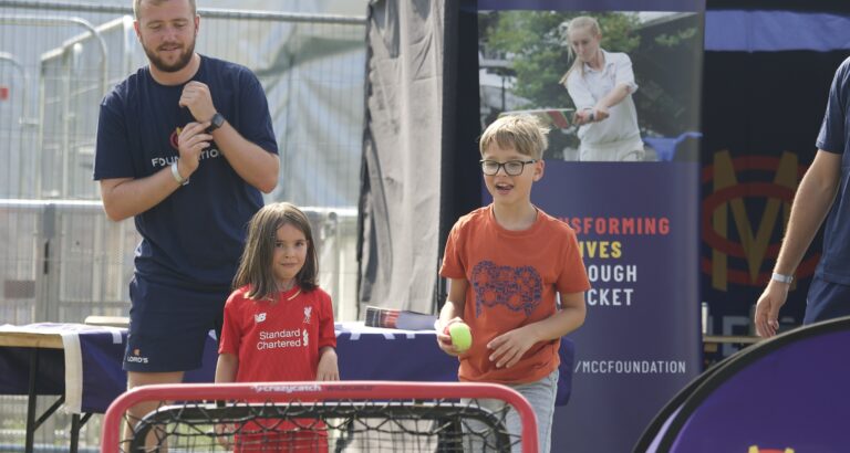 Lords Community Cricket volunteers playing a match with kids at BST Open House