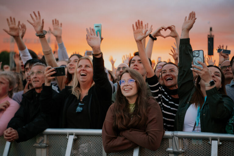 Crowd watching a headliner at sunset at BST Hyde Park