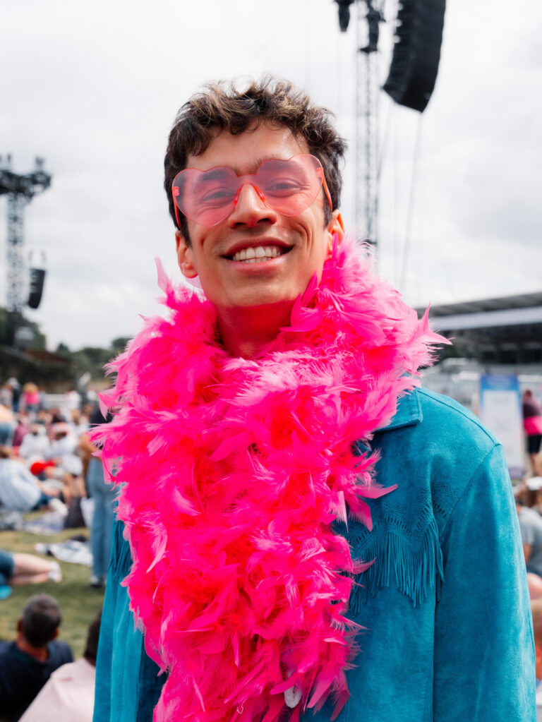 An Elton John fan in a feather boa at BST Hyde Park 2022